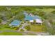 Aerial view of clubhouse and surrounding landscape at 7628 Whitebridge Gln, University Park, FL 34201