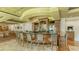 Community clubhouse bar with seating and granite countertop at 7628 Whitebridge Gln, University Park, FL 34201