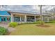 Modern clubhouse exterior with covered patio and landscaping at 7628 Whitebridge Gln, University Park, FL 34201