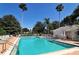 Community pool with adjacent lounge area at 7628 Whitebridge Gln, University Park, FL 34201