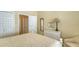 Comfortable guest bedroom with a queen bed and adjacent bathroom at 7741 Whitebridge Gln, University Park, FL 34201