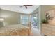 Spacious bedroom with a king-size bed, dresser, and access to a private patio at 7741 Whitebridge Gln, University Park, FL 34201