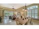 Open dining room with a view into living room and kitchen at 7741 Whitebridge Gln, University Park, FL 34201