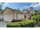 Two-car garage, attractive landscaping, and a charming front entrance at 7741 Whitebridge Gln, University Park, FL 34201