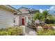 Welcoming entryway with red door and a brick pathway at 7741 Whitebridge Gln, University Park, FL 34201