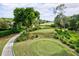 Elevated view of the golf course with putting green at 7741 Whitebridge Gln, University Park, FL 34201