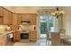 Well-equipped kitchen featuring granite counters, stainless steel appliances, and access to a patio at 7741 Whitebridge Gln, University Park, FL 34201