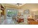 Bright living room with comfy seating, large TV, and sliding glass doors leading to a screened patio at 7741 Whitebridge Gln, University Park, FL 34201