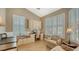 Bright home office with built-in desk and seating area at 7741 Whitebridge Gln, University Park, FL 34201