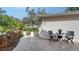 Cobblestone patio with a small gate and lush landscaping at 7741 Whitebridge Gln, University Park, FL 34201