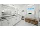 Modern bathroom with double vanity, marble flooring, and a large mirror at 8358 Redonda Loop, Lakewood Ranch, FL 34202