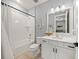 Clean bathroom with white vanity, subway tile, and a bathtub at 8358 Redonda Loop, Lakewood Ranch, FL 34202