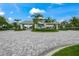 Gated community entrance with palm trees and a paved circular drive at 8358 Redonda Loop, Bradenton, FL 34202