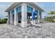 Covered outdoor grill area with seating at 8358 Redonda Loop, Lakewood Ranch, FL 34202