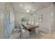 Bright dining room features a large wooden table, white chairs, and stylish wall decor at 8358 Redonda Loop, Lakewood Ranch, FL 34202