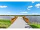 Wooden dock extending over calm lake waters at 8358 Redonda Loop, Lakewood Ranch, FL 34202
