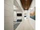Long hallway with wood-look floors and a modern feel, leading to other rooms at 8358 Redonda Loop, Lakewood Ranch, FL 34202
