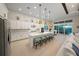 Bright kitchen features white cabinets, center island and breakfast bar at 8358 Redonda Loop, Lakewood Ranch, FL 34202