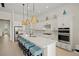 Modern kitchen with white cabinets, quartz countertops, and a large island at 8358 Redonda Loop, Lakewood Ranch, FL 34202