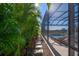 Landscaped walkway leading to a screened pool area at 8358 Redonda Loop, Bradenton, FL 34202