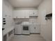 Bright laundry room with white cabinets and built-in bench at 8358 Redonda Loop, Bradenton, FL 34202