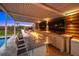 Covered outdoor kitchen features a granite countertop and fire pit at 8358 Redonda Loop, Lakewood Ranch, FL 34202