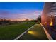 Landscaped backyard with a putting green and fire pit at 8358 Redonda Loop, Lakewood Ranch, FL 34202
