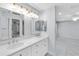 Double vanity bathroom with marble countertop at 911 Wee Burn Pl, Sarasota, FL 34243