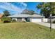 Single story home with attached garage and manicured lawn at 911 Wee Burn Pl, Sarasota, FL 34243