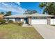 Single-story home with a two-car garage and well-manicured lawn at 911 Wee Burn Pl, Sarasota, FL 34243