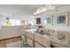 Bright dining area with spacious table and modern chandelier at 9397 Midnight Pass Rd # 404, Sarasota, FL 34242