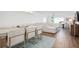 Modern dining area with glass table and light wood floors at 9397 Midnight Pass Rd # 404, Sarasota, FL 34242