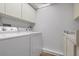 Laundry closet with full-size washer and dryer at 9397 Midnight Pass Rd # 404, Sarasota, FL 34242