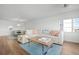 Living room with sectional sofa and light wood floors at 9397 Midnight Pass Rd # 404, Sarasota, FL 34242
