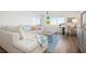 Spacious living room with light colored sectional sofa and water views at 9397 Midnight Pass Rd # 404, Sarasota, FL 34242