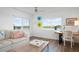 Living room with water views and comfortable seating at 9397 Midnight Pass Rd # 404, Sarasota, FL 34242