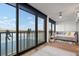 Living area with sliding doors leading to a balcony and water views at 9397 Midnight Pass Rd # 404, Sarasota, FL 34242