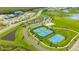 This aerial view shows the community's amenities including tennis courts, basketball court, and recreation center at 10109 Milky Way Cir, Sarasota, FL 34241