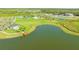 Aerial view of the neighborhood amenities that include a lake with dock, a recreation center, and sport courts at 10109 Milky Way Cir, Sarasota, FL 34241