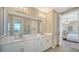 Spacious bathroom with double sinks, neutral paint, tile floors, and a shower at 10109 Milky Way Cir, Sarasota, FL 34241