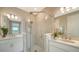 Elegant bathroom featuring dual sinks and a glass enclosed walk-in shower at 10109 Milky Way Cir, Sarasota, FL 34241