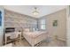 Stylish bedroom featuring a unique accent wall, white furniture, and ample natural light at 10109 Milky Way Cir, Sarasota, FL 34241