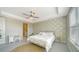 Inviting bedroom with green leafy wallpaper, a ceiling fan, and a writing desk at 10109 Milky Way Cir, Sarasota, FL 34241