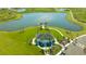 Aerial view of community clubhouse and dock overlooking the lake and well-maintained landscaping at 10109 Milky Way Cir, Sarasota, FL 34241