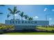 Sign for the beautiful community of Skye Ranch, in Sarasota, set amidst a lush green lawn and palm trees at 10109 Milky Way Cir, Sarasota, FL 34241