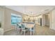 Elegant dining area with a view of the modern kitchen with stainless steel appliances at 10109 Milky Way Cir, Sarasota, FL 34241