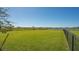 Dog park with green space with lake view and secured black fence line at 10109 Milky Way Cir, Sarasota, FL 34241