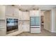 Modern kitchen featuring white cabinetry, stainless steel appliances, and stylish tile flooring at 10109 Milky Way Cir, Sarasota, FL 34241