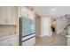 Bright kitchen with stainless steel appliances, tile backsplash, and wood-look tile flooring at 10109 Milky Way Cir, Sarasota, FL 34241