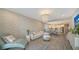 Bright living room with decorative wallpaper, chandelier, and open floor plan to the modern kitchen at 10109 Milky Way Cir, Sarasota, FL 34241